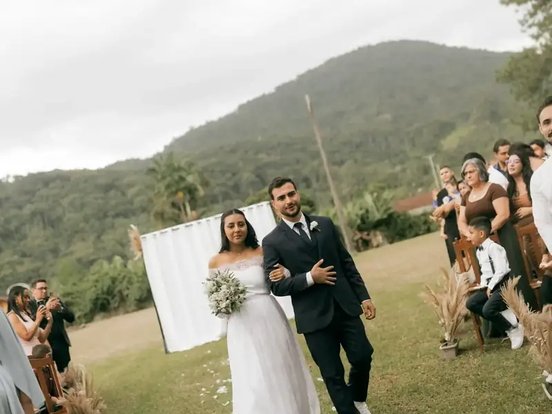 Bride and groom walking back down the aisle at an outdoor ceremony